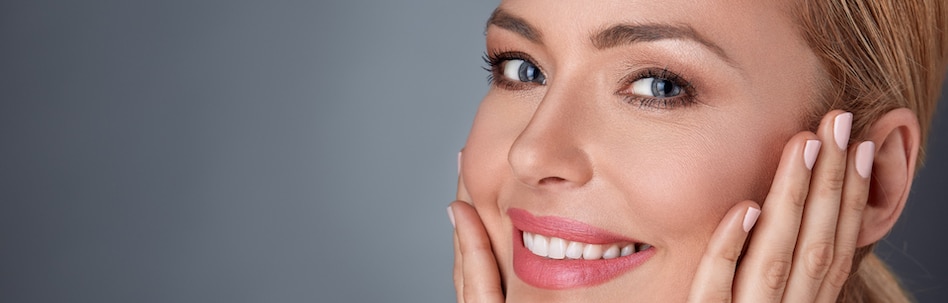 Smiling woman touching her face