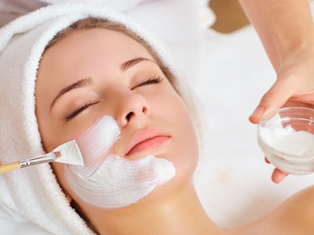 Woman in mask on face in spa beauty salon