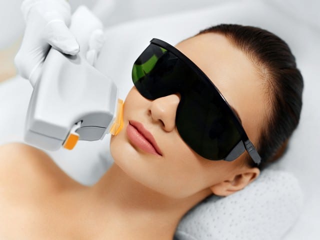 Young Woman Receiving laser Beauty Treatment