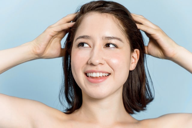 A woman smiling and showing the results of SkinPen® microneedling in Tampa, FL